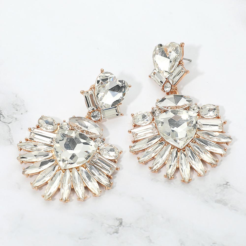 Clear Heart Crystal Fan pageant and prom earrings on gold displayed on a white marble background