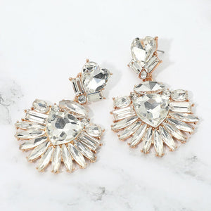 Clear Heart Crystal Fan pageant and prom earrings on gold displayed on a white marble background