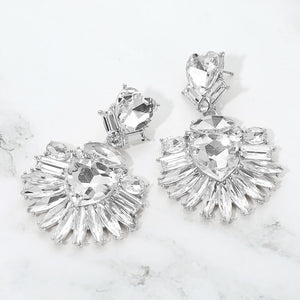 Clear Crystal Heart Crystal Fan pageant and prom earrings on silver displayed on a white marble background
