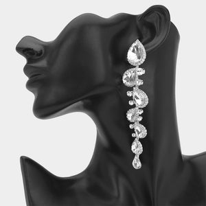 Clear long teardrop stone cluster drop evening earrings on silver on a black mannequin ear
