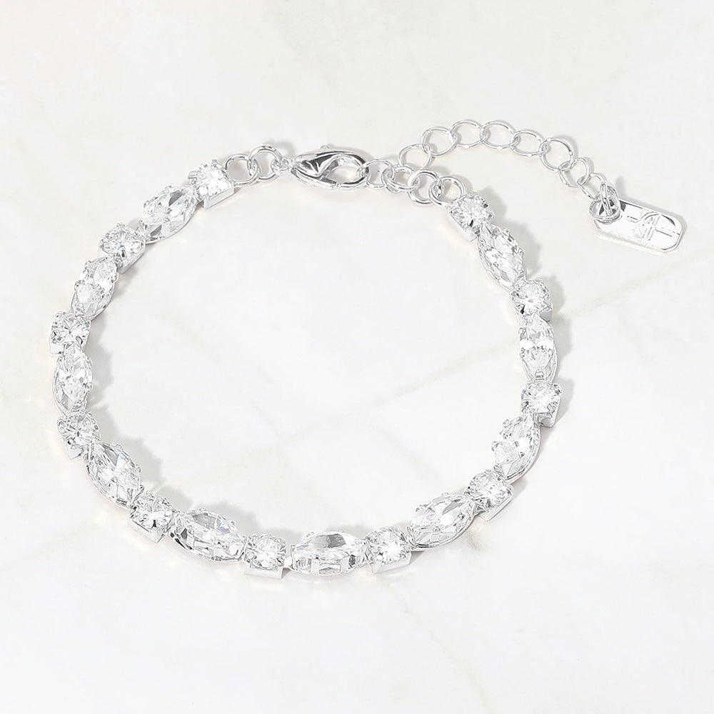 Clear marquise crystal prom bracelet on silver on white marble background