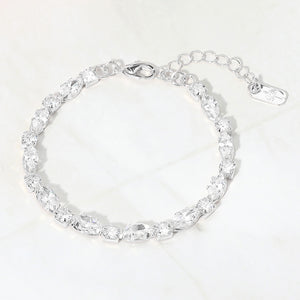 Clear marquise crystal prom bracelet on silver on white marble background