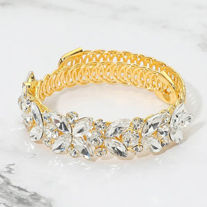Clear marquise floral crystal bracelet on gold with adjustable fit, elegant statement jewelry for prom and evening wear on a marble background