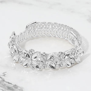 Clear marquise floral crystal bracelet on silver with adjustable fit, elegant statement jewelry for prom and evening wear on a marble background