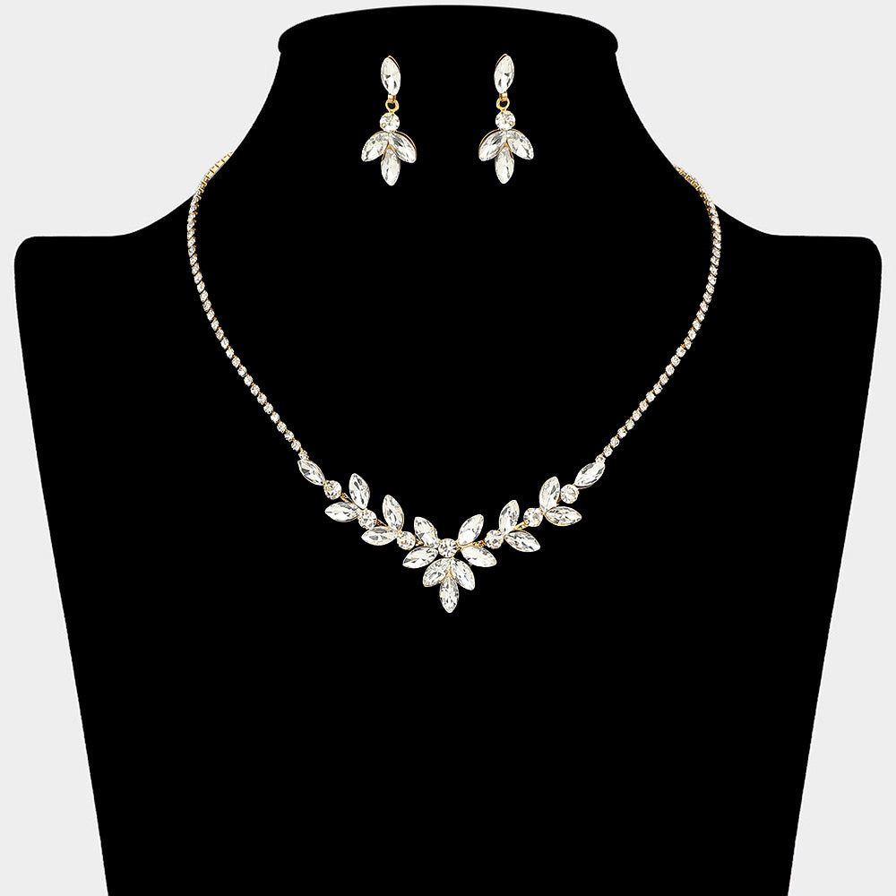Clear marquise leaf necklace set on gold with matching earrings for prom and evening wear on a black mannequin bust on a white background.