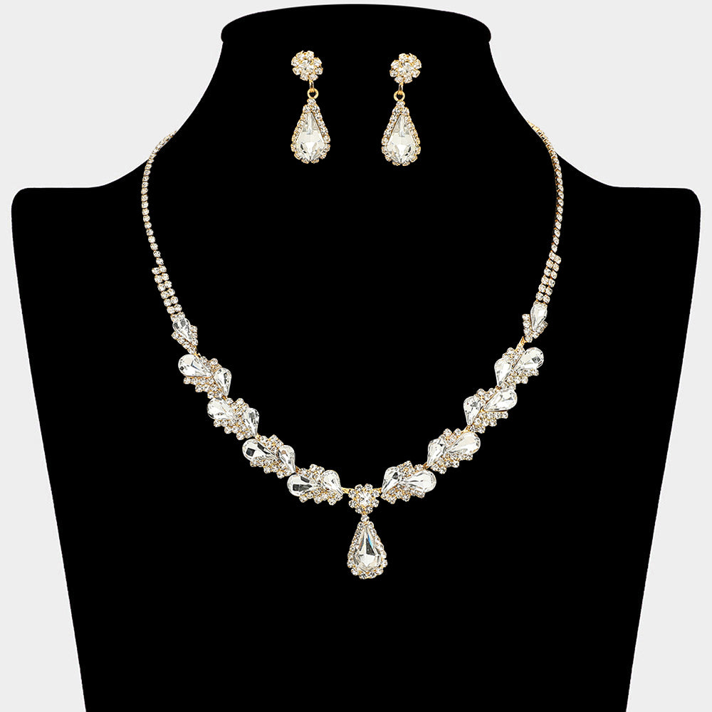 Clear marquise pendant necklace set on gold with matching earrings for prom and evening wear on a black mannequin bust on a white background.
