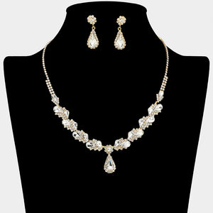 Clear marquise pendant necklace set on gold with matching earrings for prom and evening wear on a black mannequin bust on a white background.