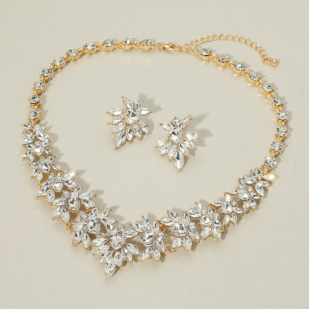 Clear marquise floral statement necklace set on gold on a beige background