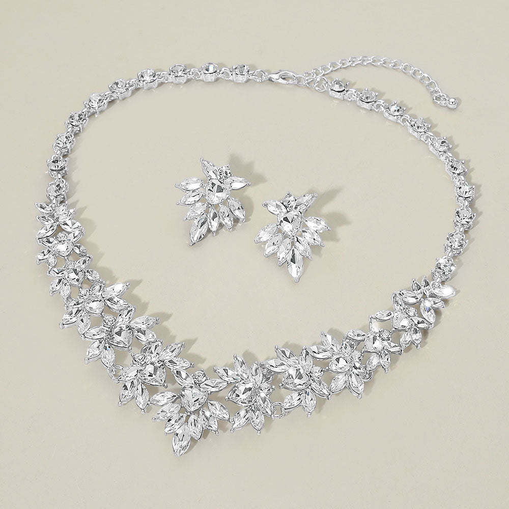 Clear marquise floral statement necklace set on silver on a beige background