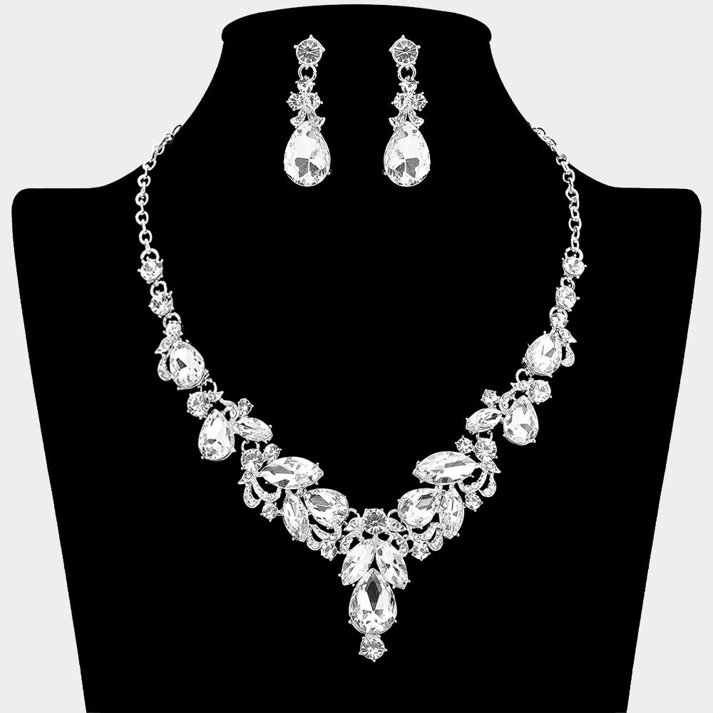 Clear marquise stone cluster necklace with teardrop rhinestone design, matching earrings, on a black mannequin bust, for prom or formal events