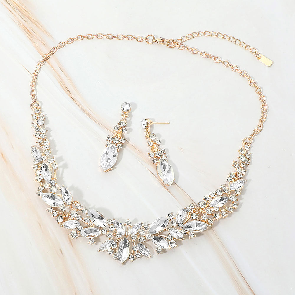 Clear marquise stone cluster prom and evening necklace set on gold on white marble background