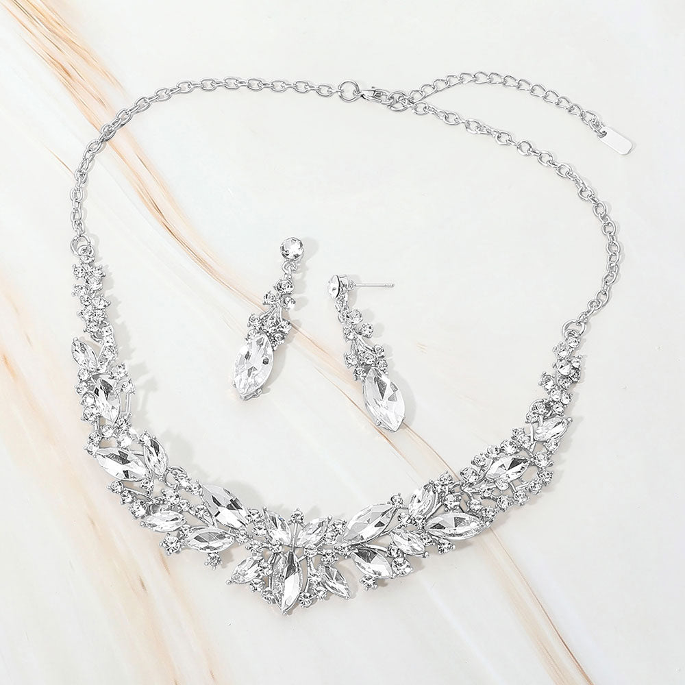 Clear marquise stone cluster prom and evening necklace set on silver on white marble background