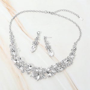 Clear marquise stone cluster prom and evening necklace set on silver on white marble background