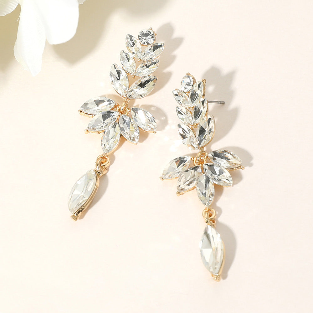 Clear crystal marquise stone cluster leaf drop earrings on gold with elegant dangling accent, 2.5 inch statement earrings on a light beige background
