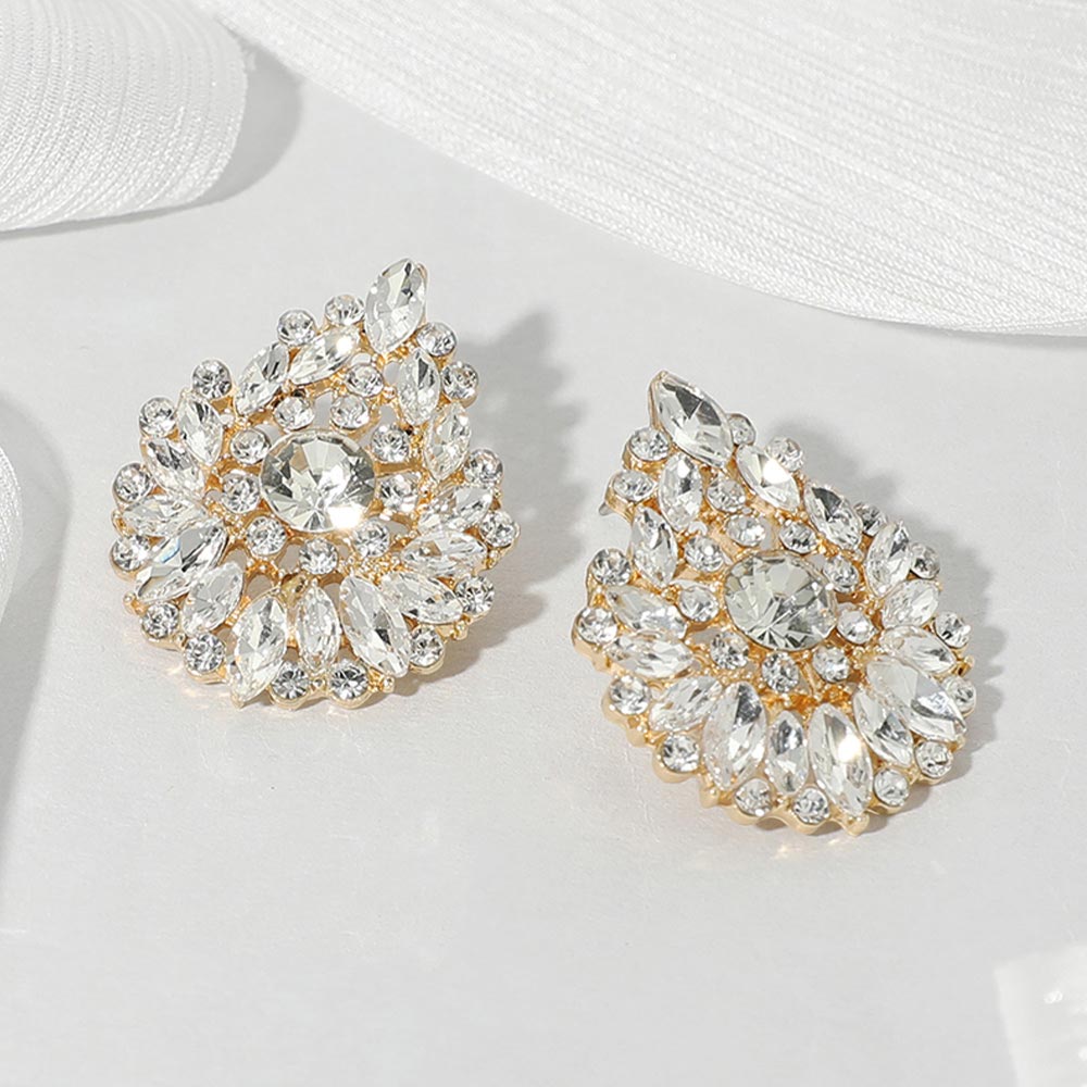Clear marquise stone cluster teardrop earrings on gold on a white background