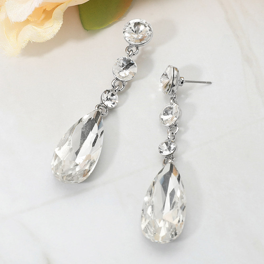 Clear rhinestone multi stone dangle earrings with teardrop crystal for weddings or pageants on a white background
