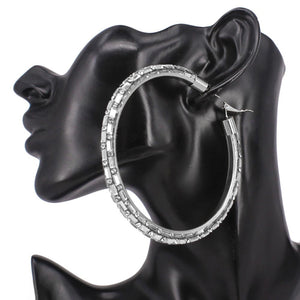 Clear oversized baguette rhinestone hoop earrings on silver with omega back on a black mannequin ear