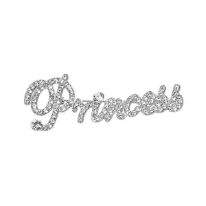 Silver-tone “Princess” brooch with clear crystals covering flowing, connected script lettering and a large looping capital P, measuring approximately 2.8 inches wide by 1.1 inches tall, displayed on a white background.
