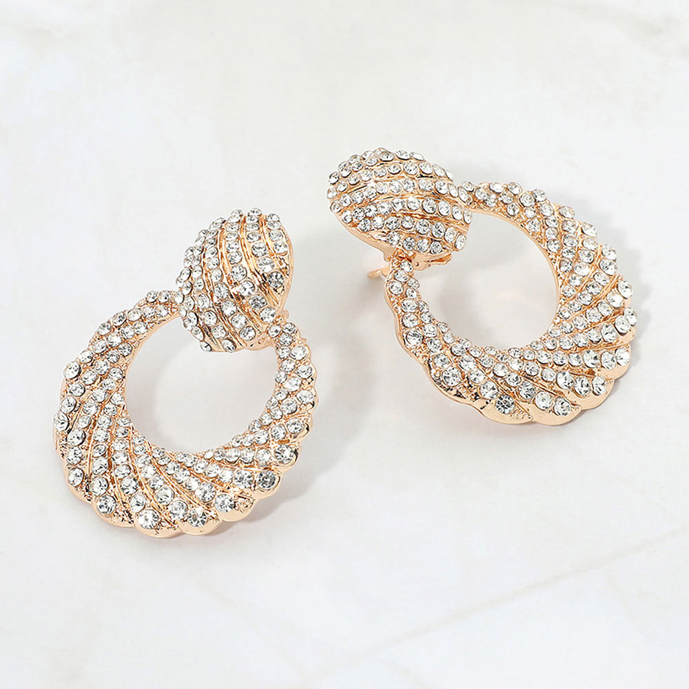 Clear rhinestone pavé door knocker clip-on earrings on gold on a white background