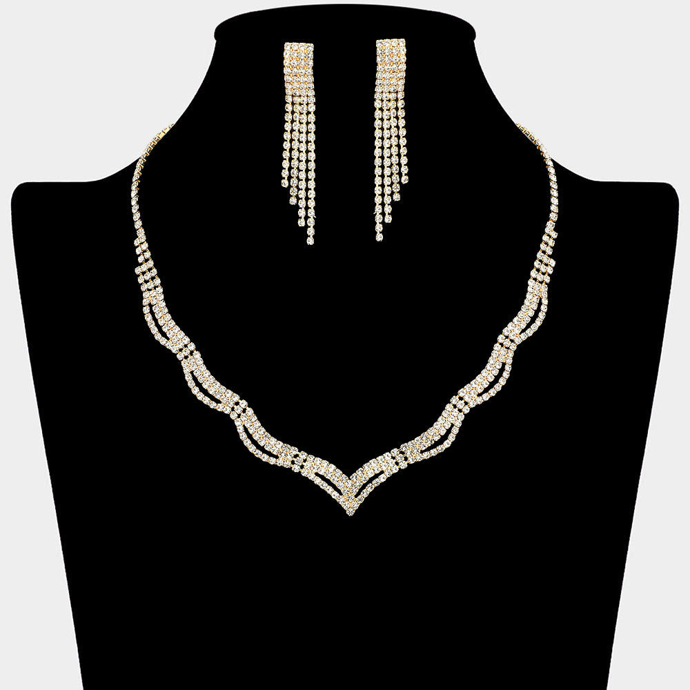 Clear crystal wavy necklace and earring set on gold for formal events and pageants on a black mannequin bust on a white background.