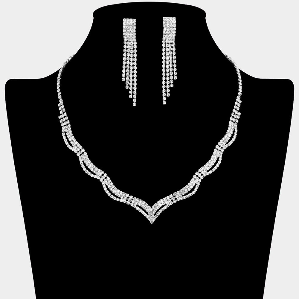 Clear rhinestone wavy necklace set on silver with matching earrings for prom and evening wear on a black mannequin bust on a white background.