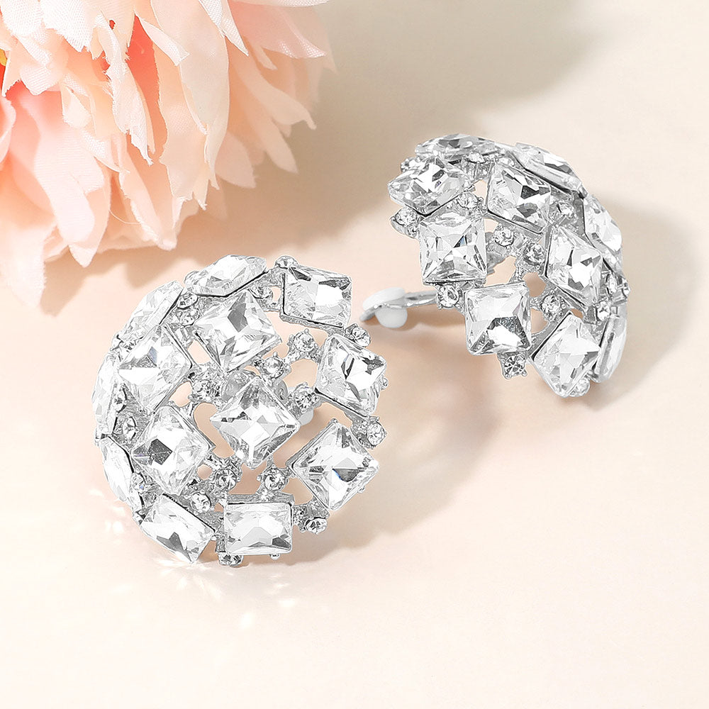 Clear square stone cluster dome clip-on earrings with a geometric rhinestone design and silver-tone setting on a light background with flowers
