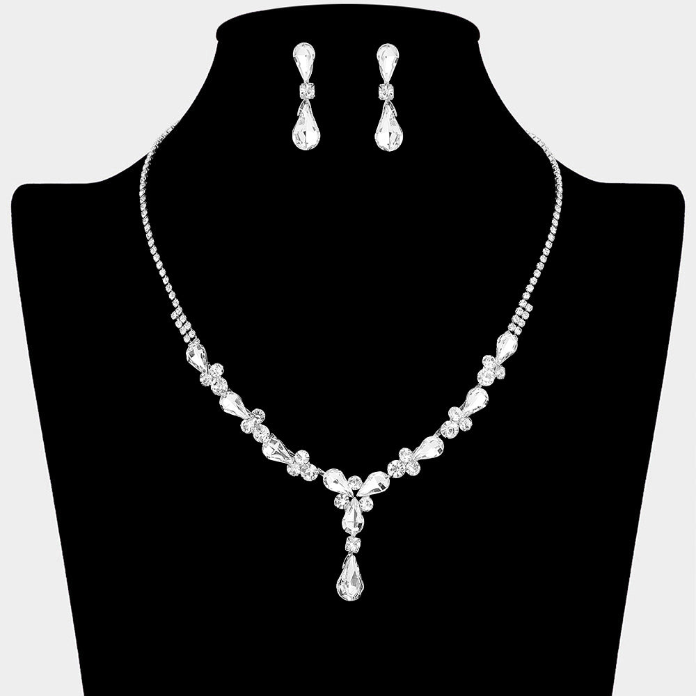 Clear crystal teardrop necklace and earring set on silver for formal events and pageants on a black mannequin bust on a white background.
