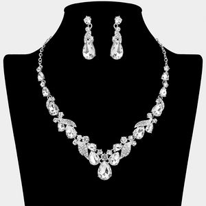 Clear teardrop leaf prom necklace set on silver with matching earrings displayed on a black mannequin bust on a white background.