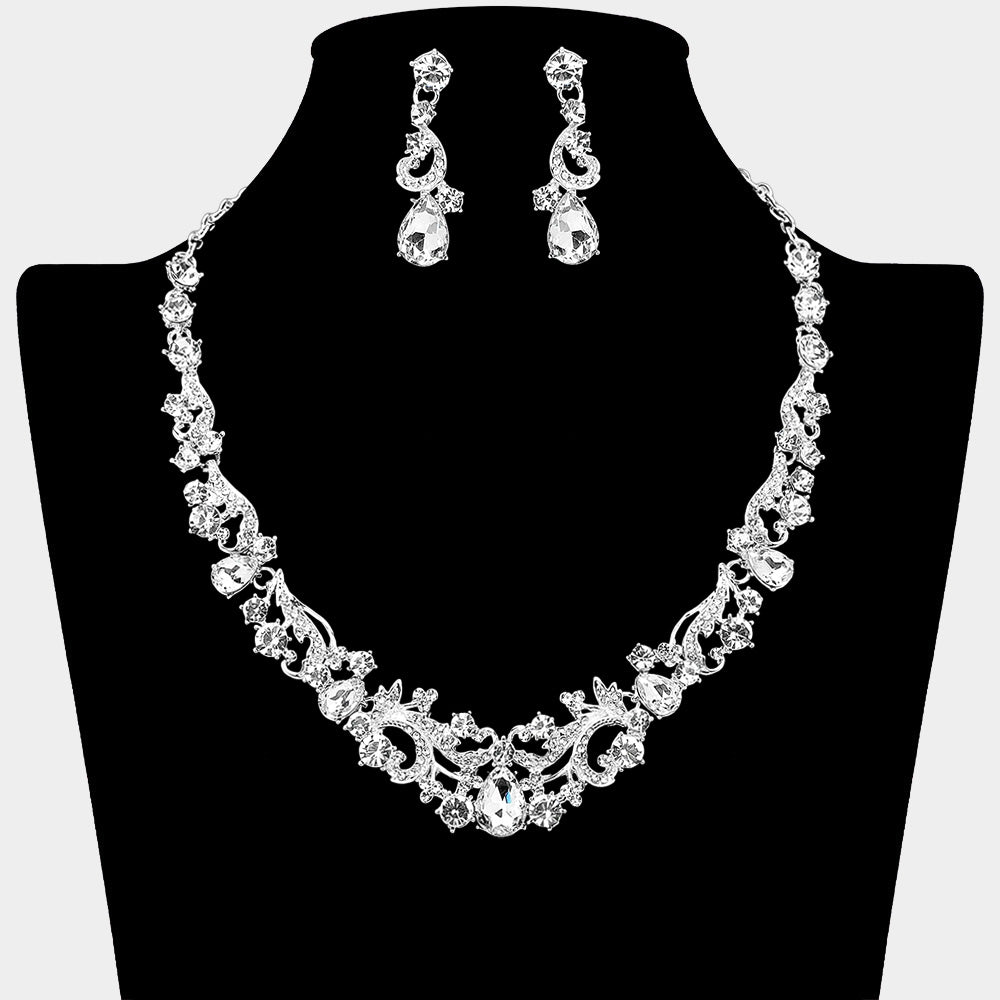 Clear teardrop rhinestone cluster necklace set on silver with matching earrings for prom and formal wear. Shown here on a black mannequin bust.
