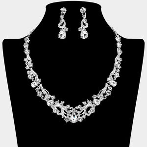 Clear teardrop rhinestone cluster necklace set on silver with matching earrings for prom and formal wear. Shown here on a black mannequin bust.
