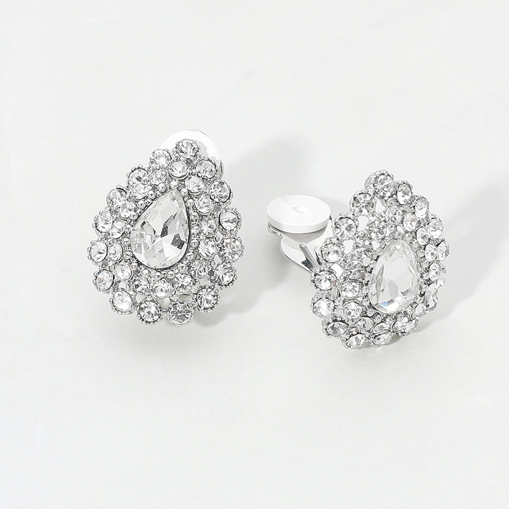 Clear teardrop rhinestone halo clip-on earrings with silver-tone setting and crystal cluster design on a light gray background