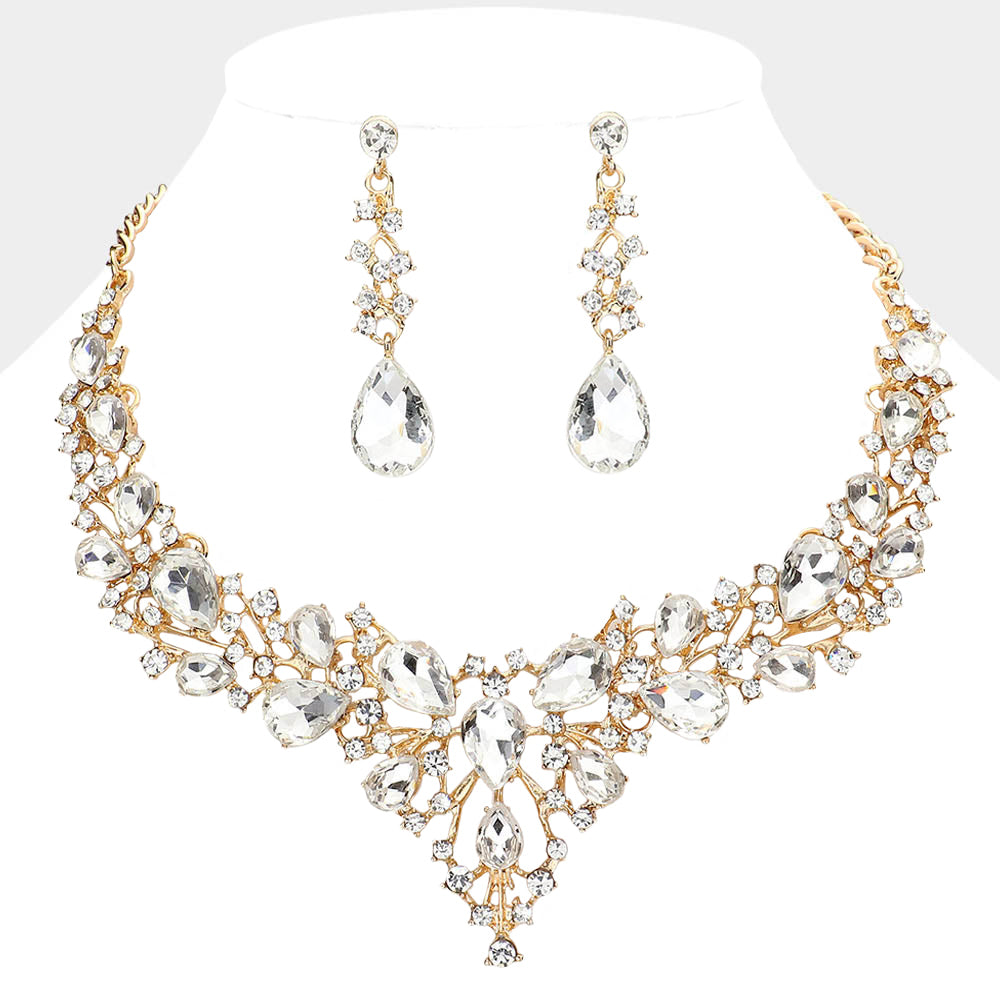 Clear teardrop and round stone statement necklace set with matching drop earrings on gold on white background