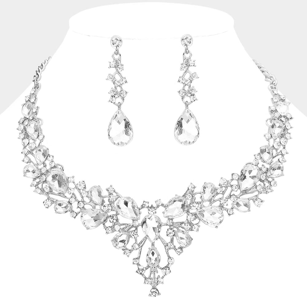 Clear teardrop and round stone statement necklace set with matching drop earrings on silver on white background