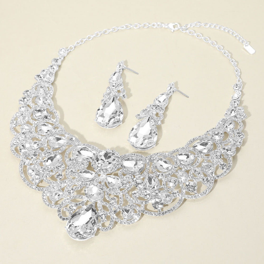 Clear teardrop statement collar necklace and earring set on silver for pageant, gala, or evening wear on an ivory background