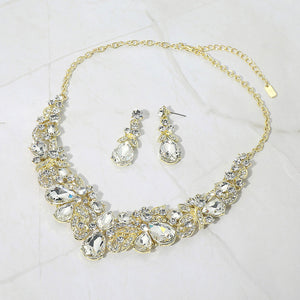 Clear teardrop floral statement necklace set on gold displayed on white background
