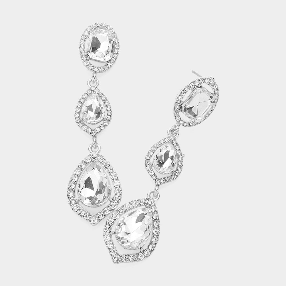Pair of silver-tone drop earrings featuring large clear oval and pear-shaped crystals surrounded by small clear stones on a light gray background.