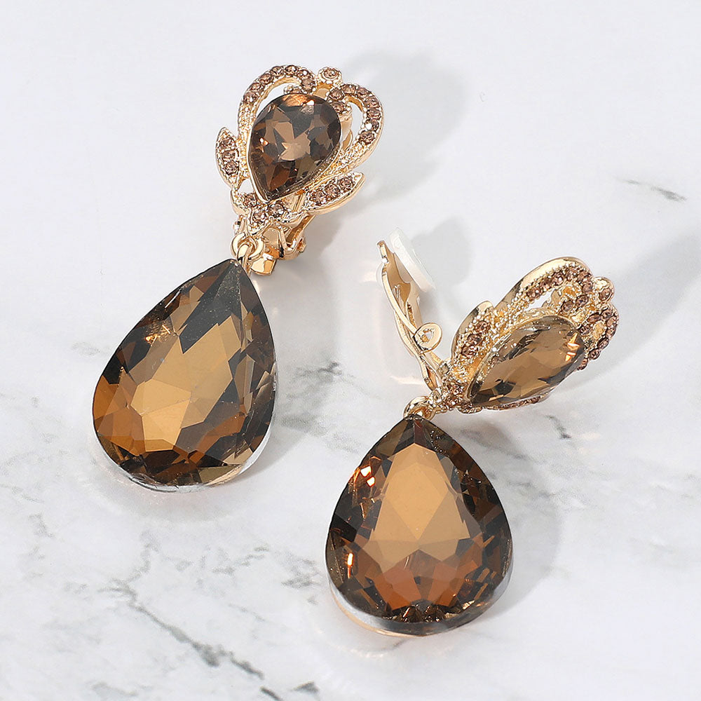 Copper Brown faceted teardrop stone clip-on earrings on gold. Top stone is elegantly surrounded by an array of rhinestones in a flower like setting. 
