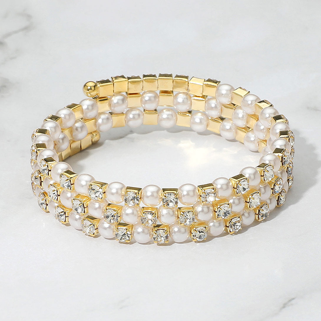 Cream Pearl and Rhinestone Lined Ajustable Coil Like Bracelet on a gray background