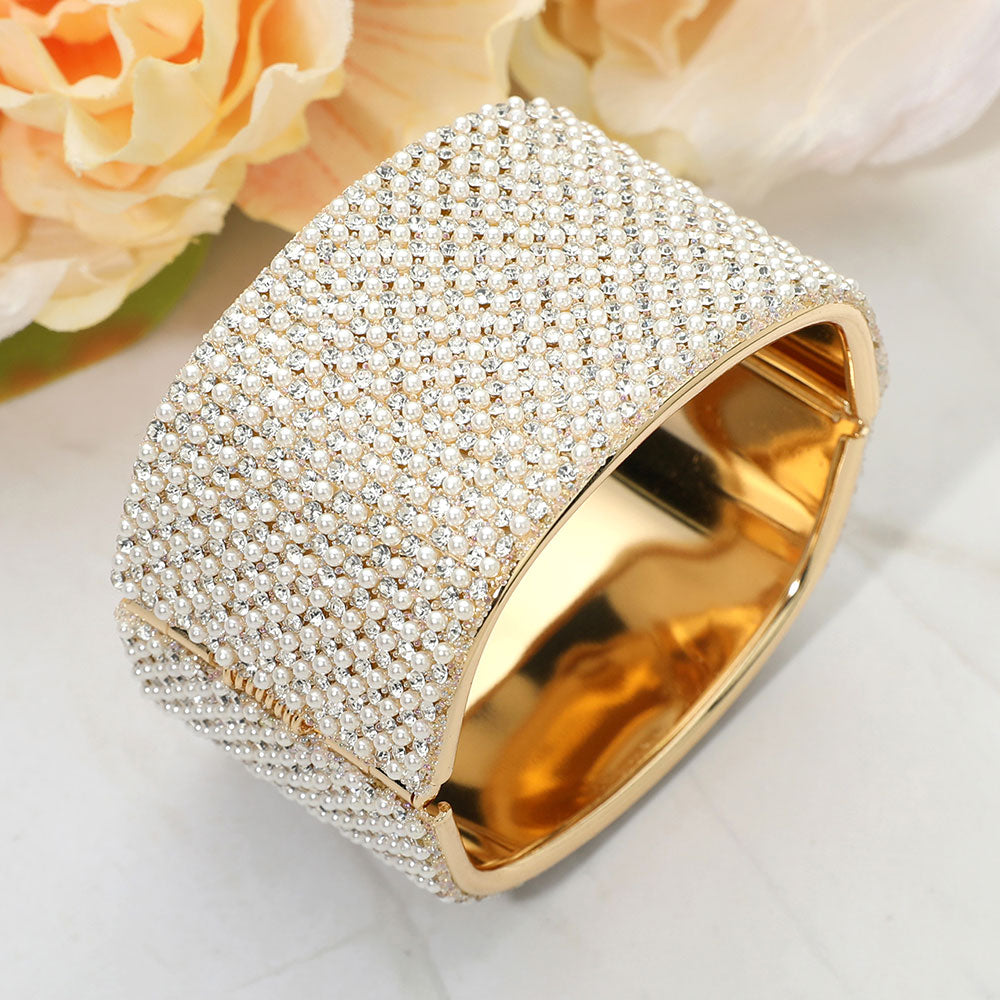 Gold bracelet with diamond accents on a light background