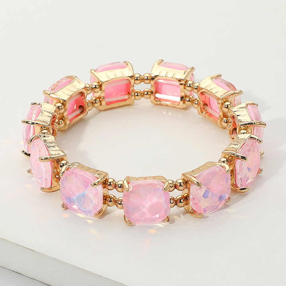 Pink opal cushion square stone stretch evening bracelet on gold, elegant statement bracelet for evening and special occasions on a white background