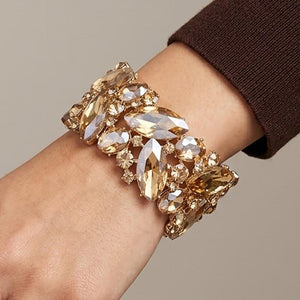 Closeup of Champagne Gold Stone Crystal Marquise Stretch Statement Bracelet on Gold on a model's wrist.