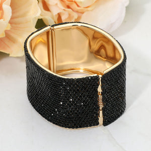Back view of jet black wide rhinestone hinged bangle bracelet showing smooth interior and secure hinge closure