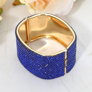 Back view of sapphire wide rhinestone hinged bangle bracelet showing smooth interior and secure hinge closure