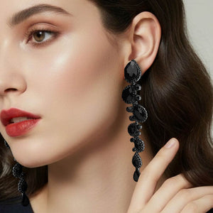 Black long teardrop pageant earrings with 4.3 inch drop shown on a model