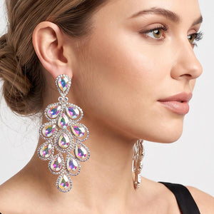 A close-up side profile of a woman wearing an extra-long ornate drop earring with cascading AB teardrop-shaped crystals, smaller accent stones, and silver-tone metal detailing.