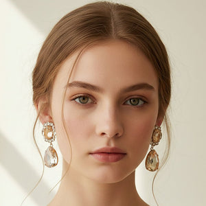 Champagne-Gold stone oval and teardrop dangle earrings on gold shown here on a model