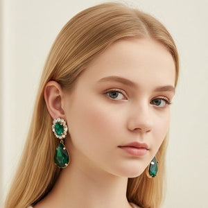 Emerald Green oval and teardrop earrings with clear crystal accents on gold shown here on a model