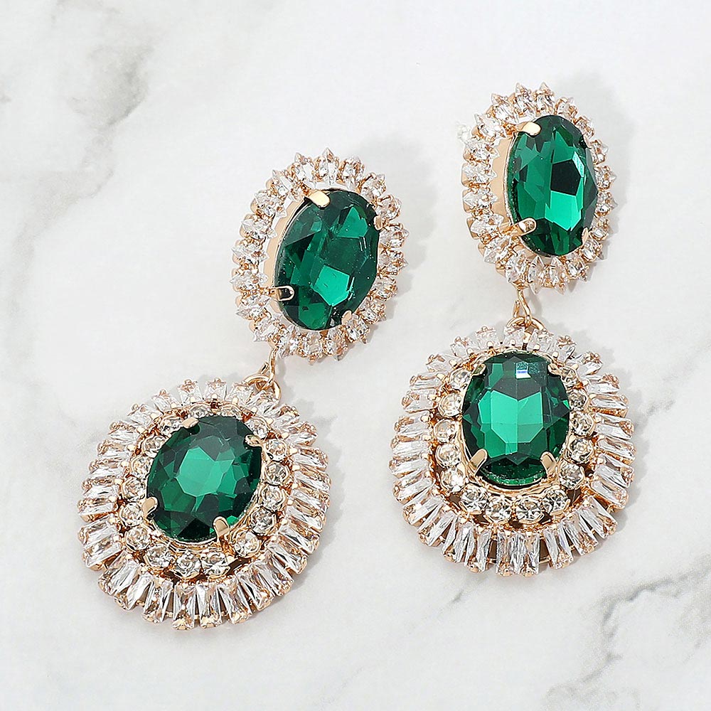 Emerald Green vintage double oval crystal statement earrings in a gold finish featuring two oval emerald green crystals surrounded by sparkling crystal halos, displayed on a white marble background.