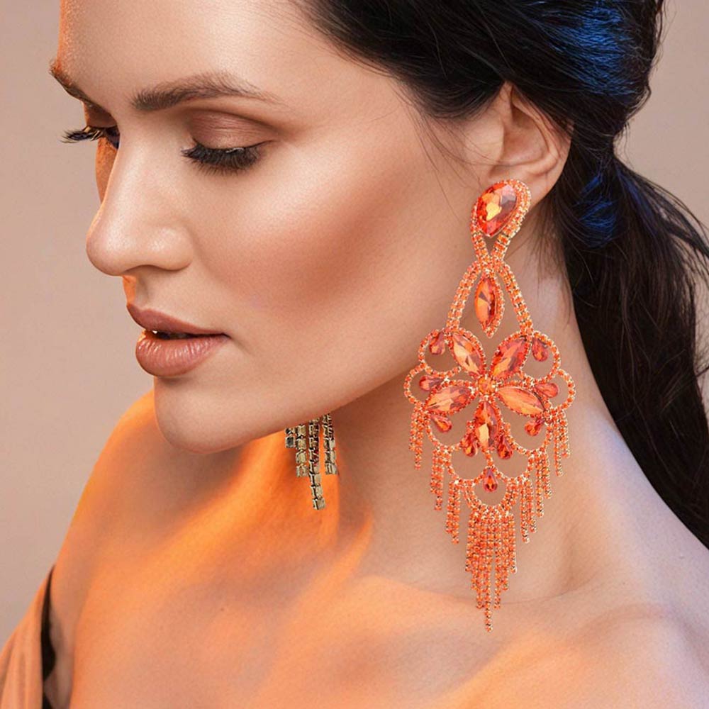 Very large orange crystal flower fringe pageant earrings on gold worn by model for pageant styling