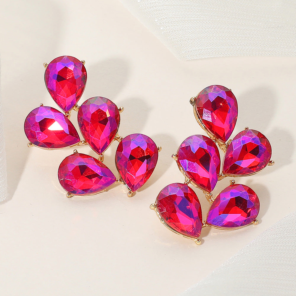 AB purple teardrop cluster earrings on gold for prom, pageant, or evening events on a light background.